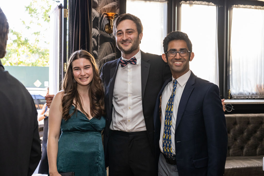 Scholars and Alumni meet and pose for a photo together in the bar at 501 Union