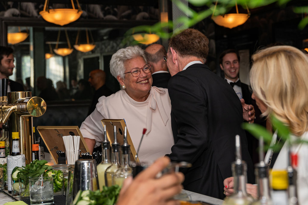 Alumni and staff from the Thouron Award catch up at the bar at 501 Union