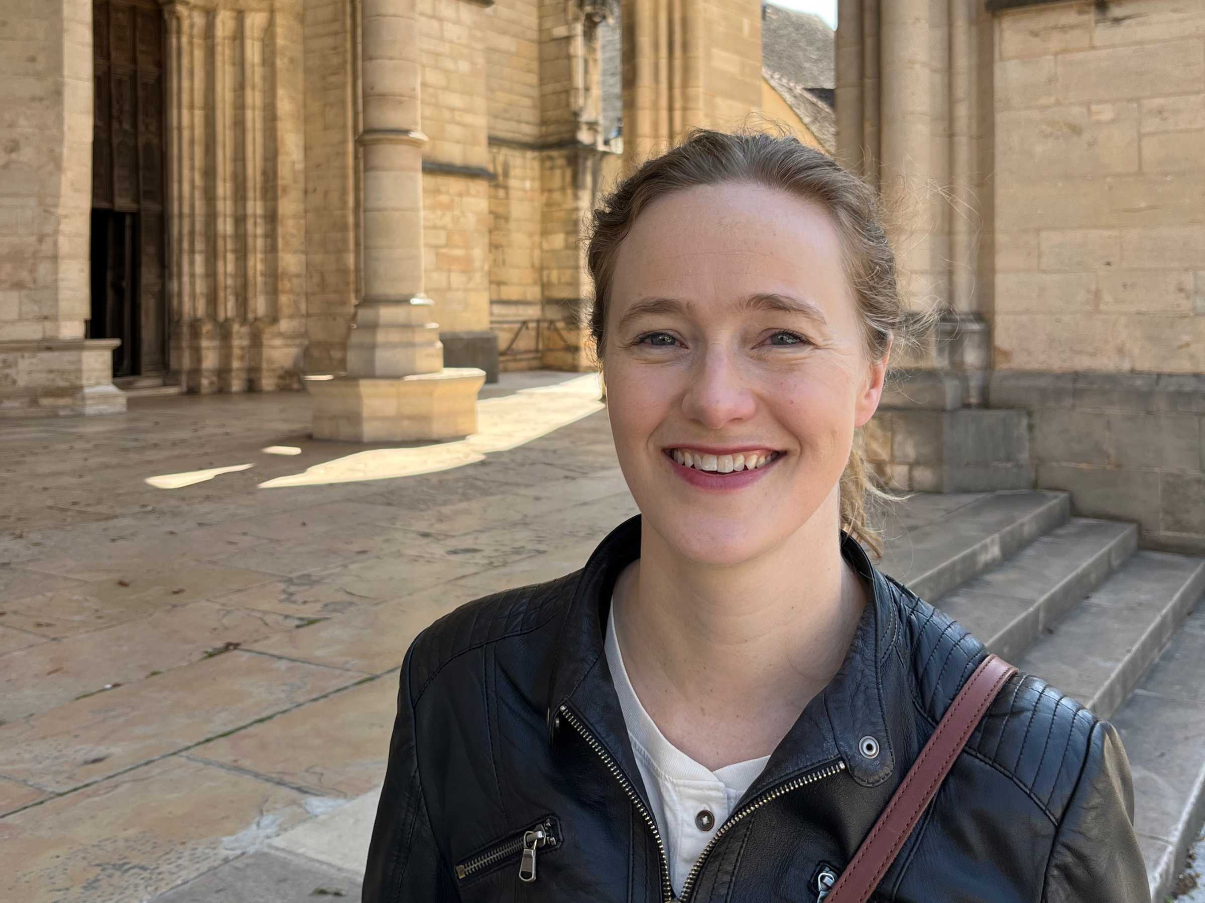 Ruth M McAdams stands in front of steps leading to a colonnade