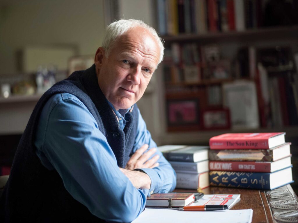 Justin Marozzi sits at his desk in his home in eastern England.