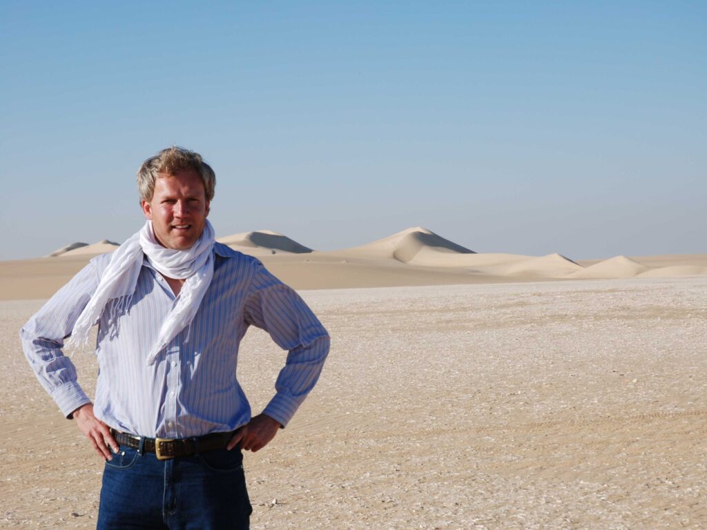 Justin stands in the desert while traveling to the Siwa Oasis in Egypt.
