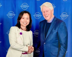 Dr Jin Lee shakes hands with President Bill Clinton